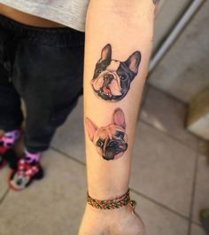 a woman's arm with two dogs on it