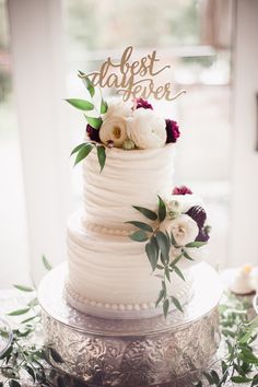 a white wedding cake with flowers on top