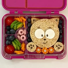 a pink lunch box filled with lots of food