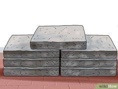 a stack of stone blocks sitting on top of a red brick floor next to a plant