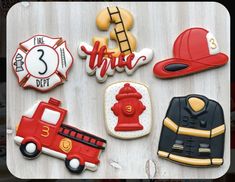 decorated cookies with firetruck, fireman's hat and fire truck on them