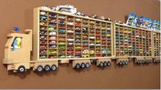 a wooden shelf filled with lots of toy cars on top of it's sides