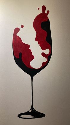 a painting of a woman's face in a glass of red wine on a white wall