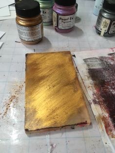 some gold paint is sitting on the table