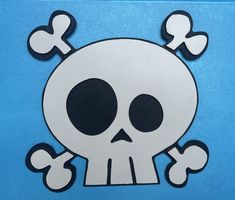 a paper cut out of a skull and crossbones on a blue background,