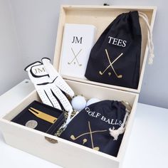 an open box containing golf accessories and a bag with the word tees on it