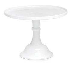 a white cake plate sitting on top of a table