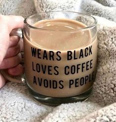 someone is holding a coffee mug that says, wears black love's coffee avoids people