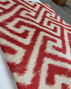 a red and white table cloth with an intricate design