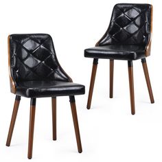 pair of black leather dining chairs with wooden legs and back upholstered in quilted design