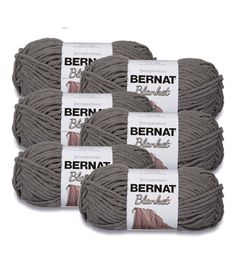 several skeins of bernat yarn are shown in grey and brown colors on a white background