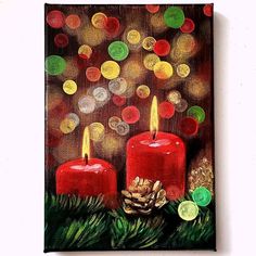 two red candles sitting on top of a wooden table next to christmas decorations and coins