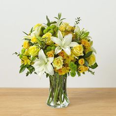 a vase filled with yellow and white flowers