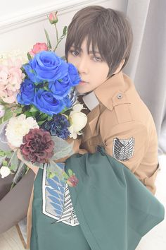 a man sitting on the floor with flowers in his lap