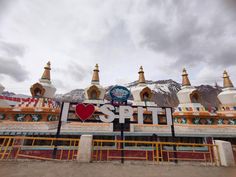 a large sign that says i love spit with mountains in the background