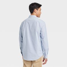 From work meetings to evening outings, stay cool, comfy and stylish in this Performance Dress Long-Sleeve Button-Down Shirt from Goodfellow & Co™. Tailored in a standard fit, this button-down shirt is crafted from a soft fabric blend with a hint of spandex for stretchy comfort. Designed with a collared neckline for classic style, you can wear it tucked in with dress pants or chinos with loafers or dress shoes for a special event, or sport it untucked with jean shorts or chambray pants for a more Casual Dress Shirt With Placket For Office, Casual Office Dress Shirt With Placket, Casual Dress Shirt With Relaxed Fit For Office, Casual Dress Shirt For Office In Fall, Casual Fall Dress Shirt For Office, Blue Long Sleeve Dress Shirt For Fall, Casual Button-up Dress Shirt For Office, Light Blue Casual Dress Shirt For Business, Light Blue Casual Dress Shirt For Business Casual