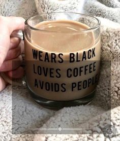 someone is holding a coffee mug that says, wears black love's coffee avoids people