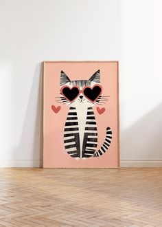 a cat with heart shaped glasses on it's face sitting in front of a wall