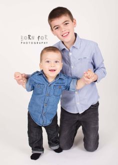 two young boys posing for the camera with their arms around each other