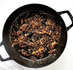 a pan filled with food sitting on top of a white table