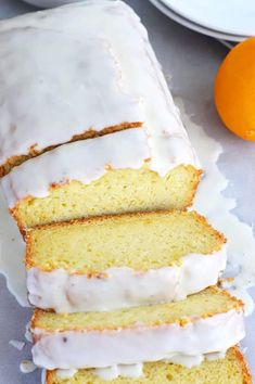 a loaf of lemon pound cake sitting next to an orange