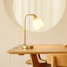 a desk lamp sitting on top of a wooden table