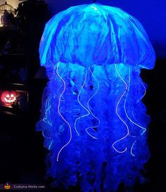 a blue light up jellyfish in the dark