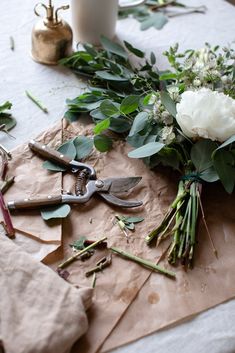 flowers and scissors are laying on the table