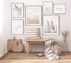 a white room with pictures on the wall and a bench in front of it,