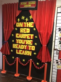 a christmas tree made out of construction paper and red curtains with the words on the carpet you're ready to learn