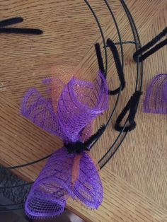 purple ribbons are tied to the side of a wooden table