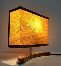 a wooden table lamp with a dim light on it