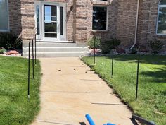 there is a blue ball on the ground in front of a house