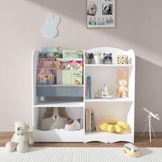 a white bookshelf with stuffed animals and toys on it in a child's room