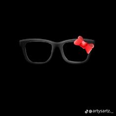 a pair of black glasses with red bows on the side and one eye in the middle