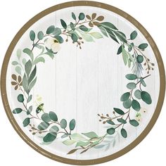 a white plate with green leaves and flowers painted on the side, along with a brown border