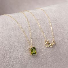 "With its shimmering pale green color, peridot stone is also known as the \"evening emerald\". It is a gemstone often associated with spirituality and expression. Our 14k solid gold peridot necklace is a stylish jewel for you and your loved ones with its elegant design. Time to pamper yourself and your loved ones... Peridot is the birthstone of August. 🤍🤍 Special gifts for your special moments. We produce our jewelery for you in the most perfect way. 🤍🤍 All of our products are made of 14K So Peridot Necklace Gold, Elegant May Birthstone Necklace With Rectangular Stone, Minimalist May Birthstone Jewelry In Rectangular Shape, Minimalist Green Necklace With Square Pendant, Green Square Pendant Necklace In Minimalist Style, Green Square Pendant Minimalist Necklace, Minimalist Green Square Pendant Necklace, Green Square Pendant Minimalist Jewelry, August Birthstone Necklace