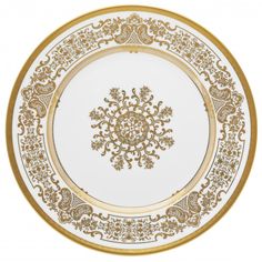 a white and gold plate with an ornate design