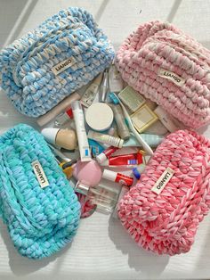 several different types of personal care items laid out on a white surface with blue and pink colors