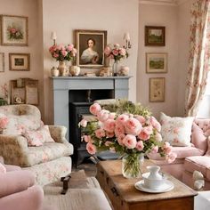 a living room filled with furniture and flowers on top of a coffee table in front of a fire place