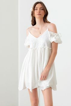 The embroidered floral shirred cold shoulder mini dress is a must-have piece for your summer wardrobe. This dress features cold shoulder cutouts, a flattering v-neckline, and adjustable straps for a customizable fit. The front is adorned with delicate embroidered floral lace detailing, adding a touch of elegance to the boho-inspired design. The tiered hem creates a flowy and feminine silhouette, perfect for a cute and casual summer look. This stylish dress is a versatile option that can be dress Daring Dress, Mustard Seed, Woven Bag, Formal Evening Dresses, Floral Mini Dress, White Mini Dress, Bold Fashion, Stylish Dresses, Fashion Sense