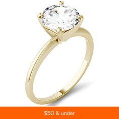 a yellow gold engagement ring with a round cut diamond in the center, on an orange background