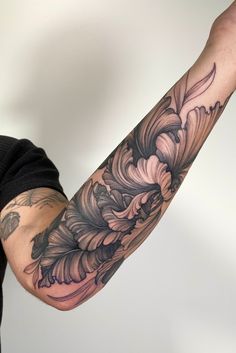 Shows an arm with fresh black linework tattoo of iris flowers. With black line details and shading. Dark Floral Sleeve, Big Tattoos For Women Arm, Floral Tattoo Design Men, Black Work Flower Tattoo, Graphic Tattoos, Forearm Tattoo Cover Up, Dark Floral Tattoo Sleeve, Forearm Tattoo Sleeve, Blackwork Floral Tattoo