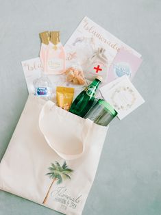 a white bag filled with personal care items on top of a table next to an envelope