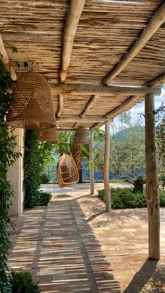 an outdoor covered patio with wicker hanging from the ceiling