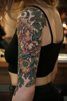 a woman with a flower tattoo on her arm