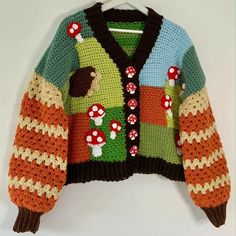 a colorful knitted sweater with mushrooms on it