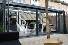 an outdoor living room and dining area with sliding glass doors