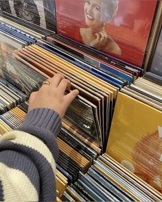 a person selecting records from a rack at a record store