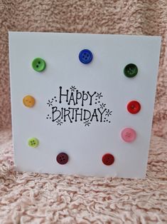 a card with buttons on it that says happy birthday